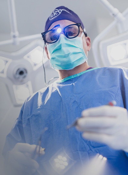 Surgeon performing a procedure in operating room.