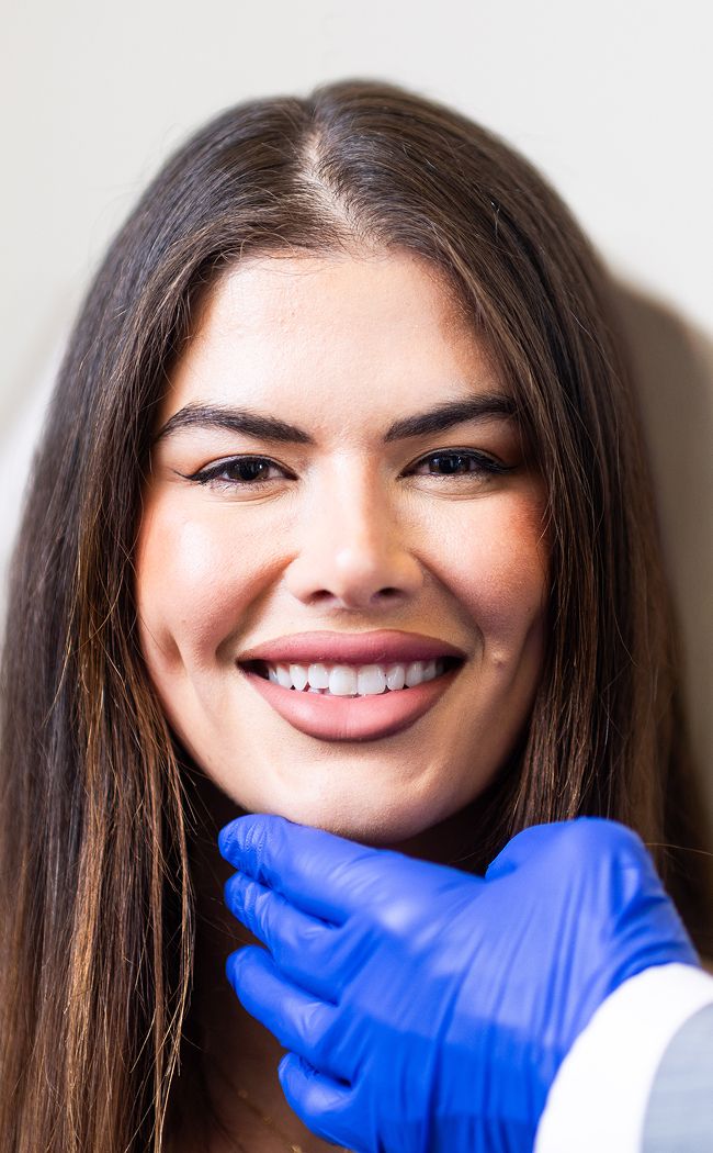 Woman smiling during dental consultation.