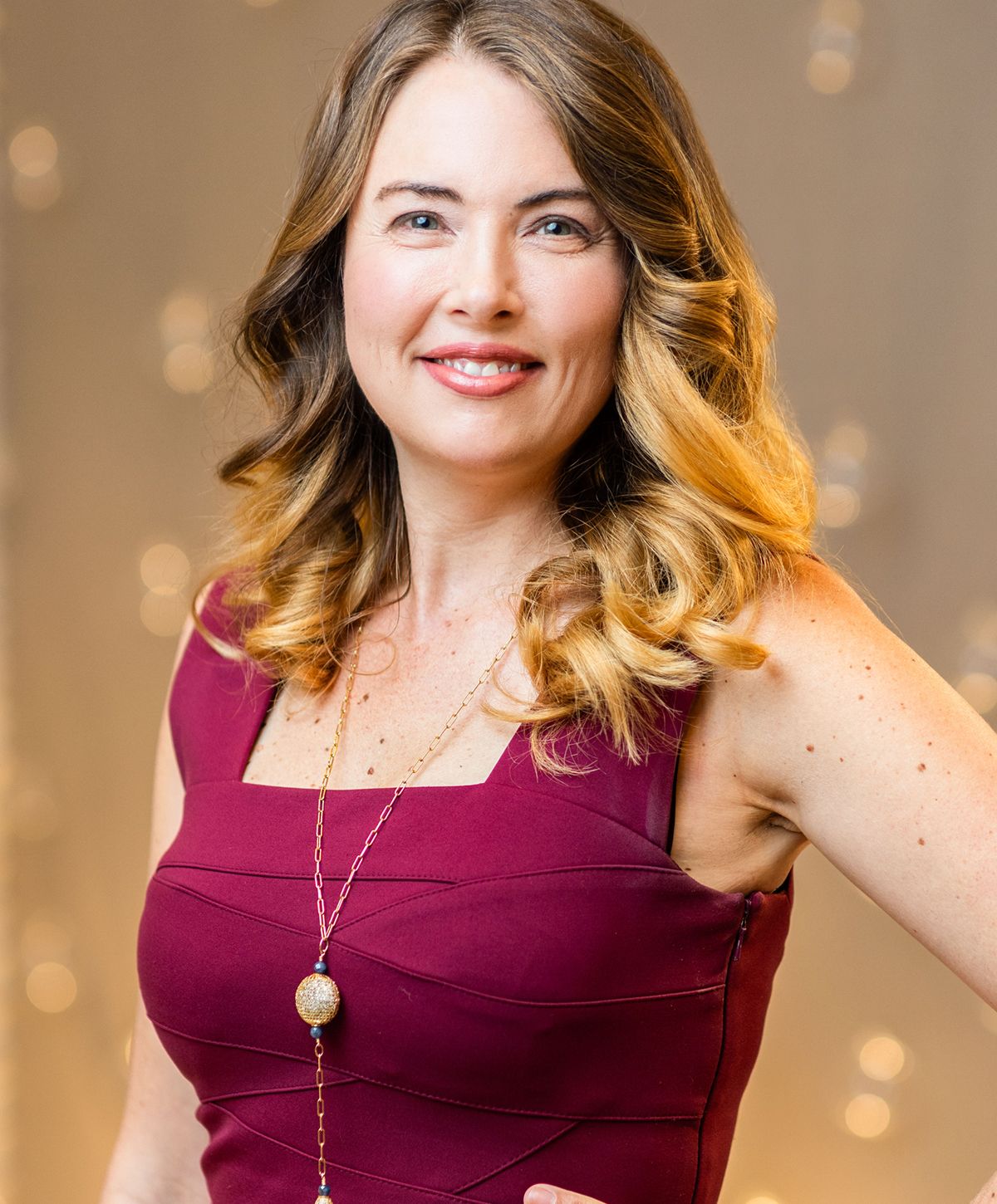 Smiling woman in elegant indoor setting.