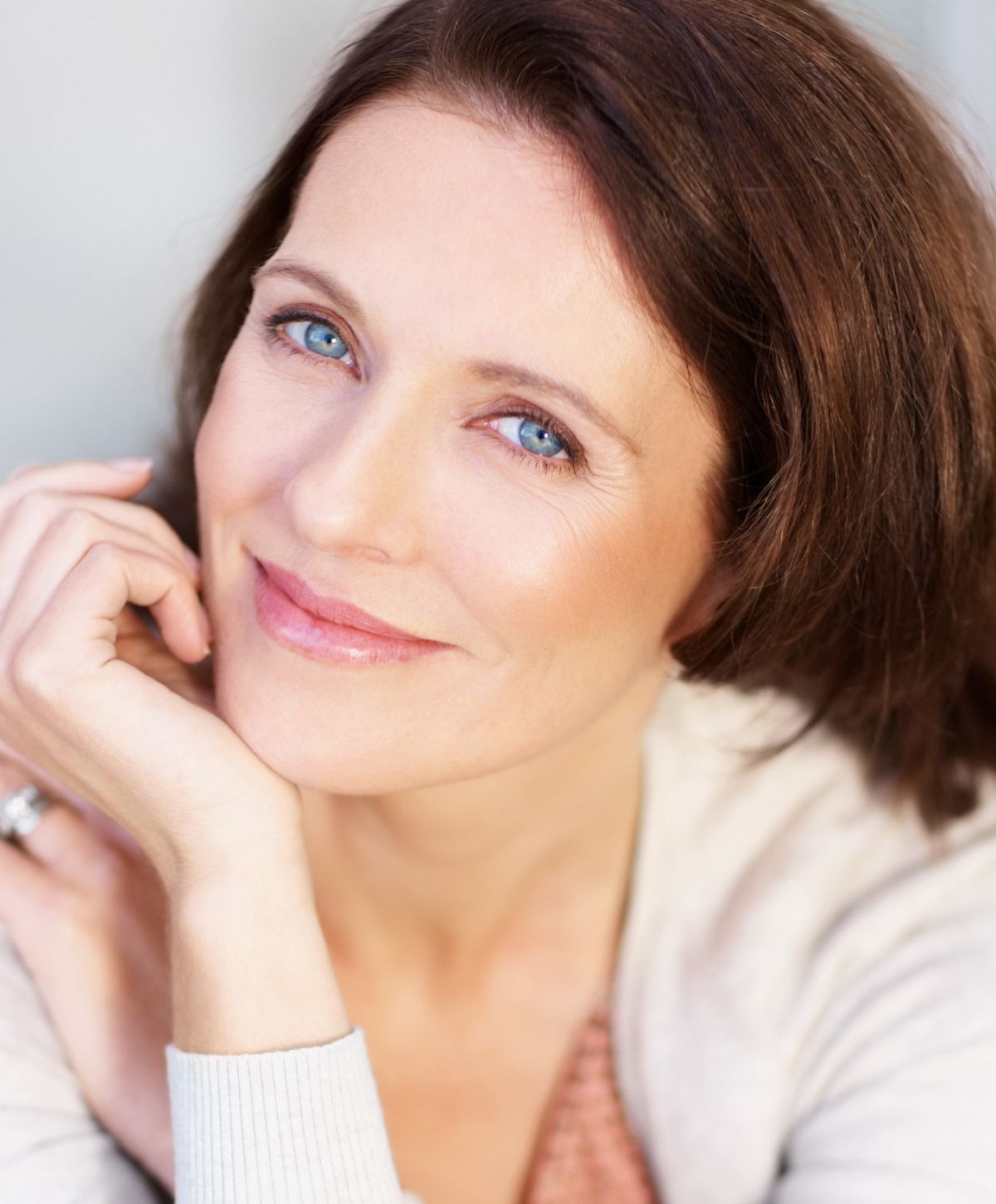 Smiling woman with blue eyes and natural makeup.
