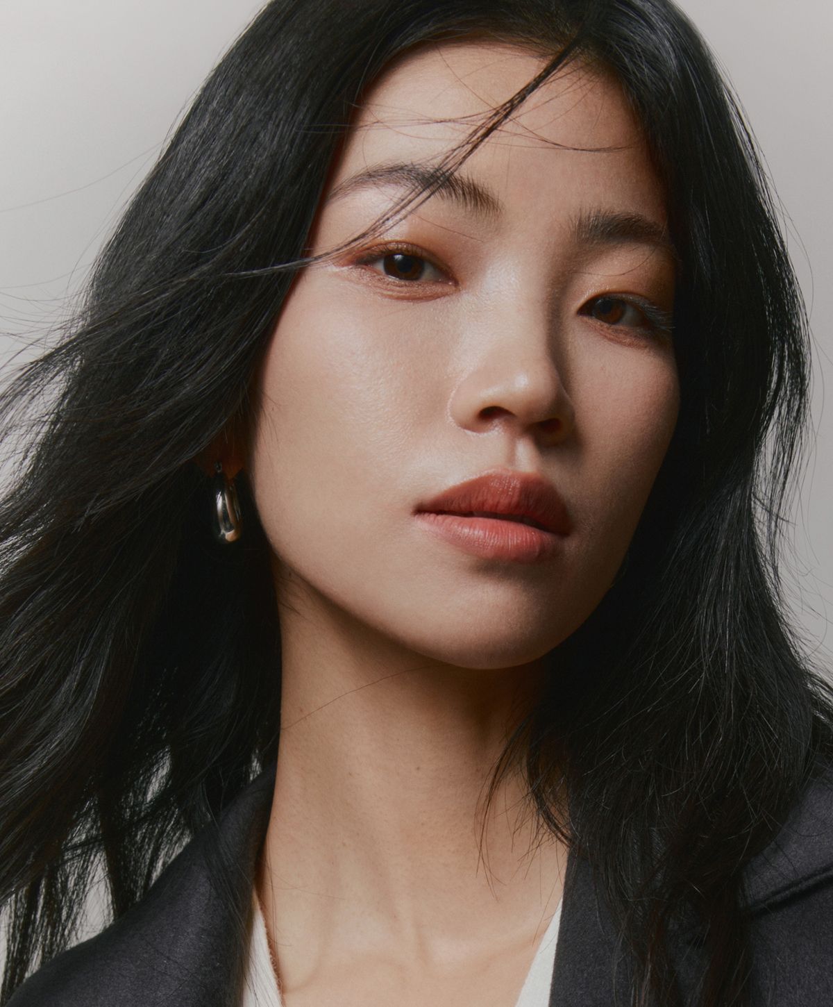 Portrait of a woman with long black hair.