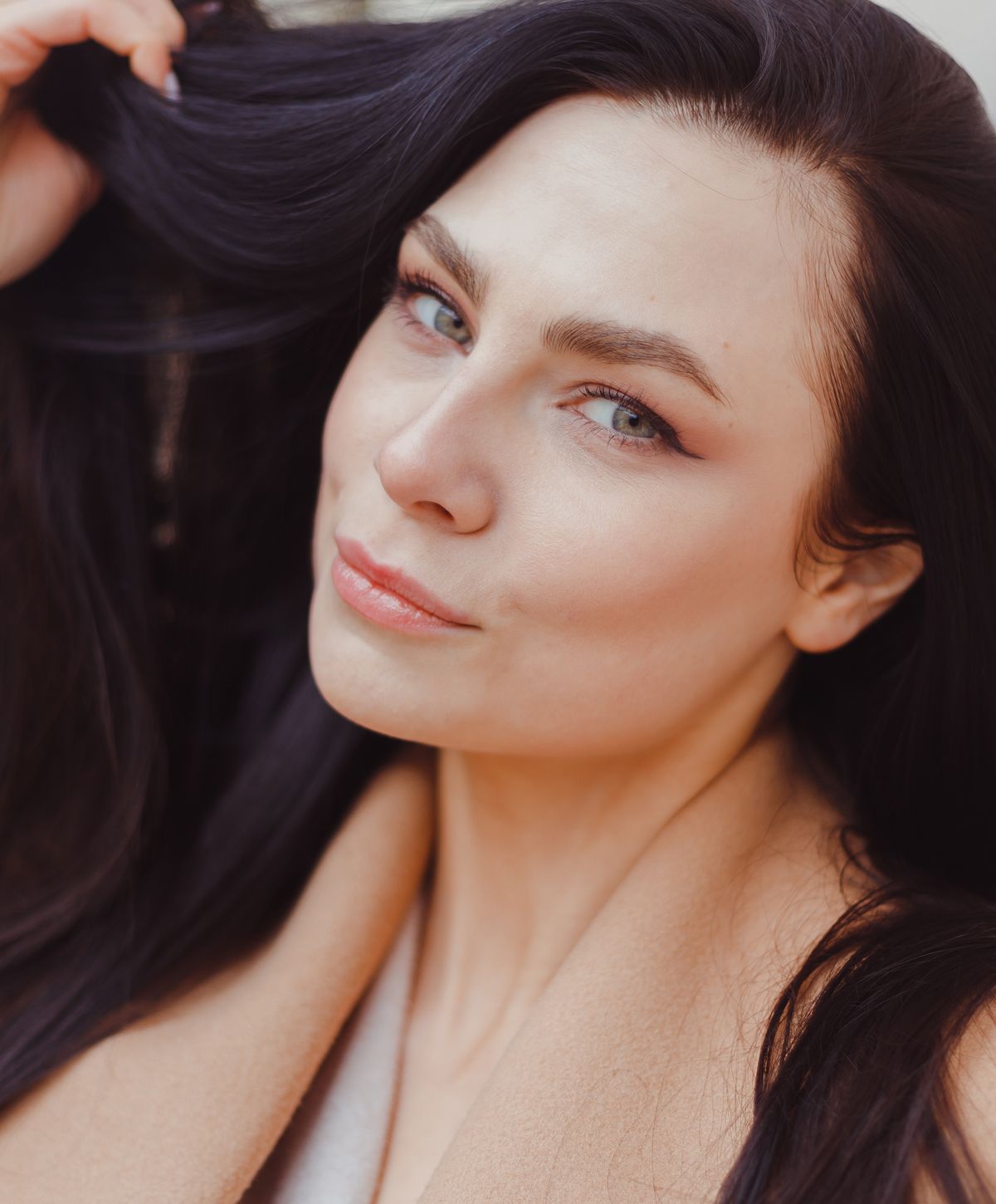 Woman with dark hair and soft makeup.