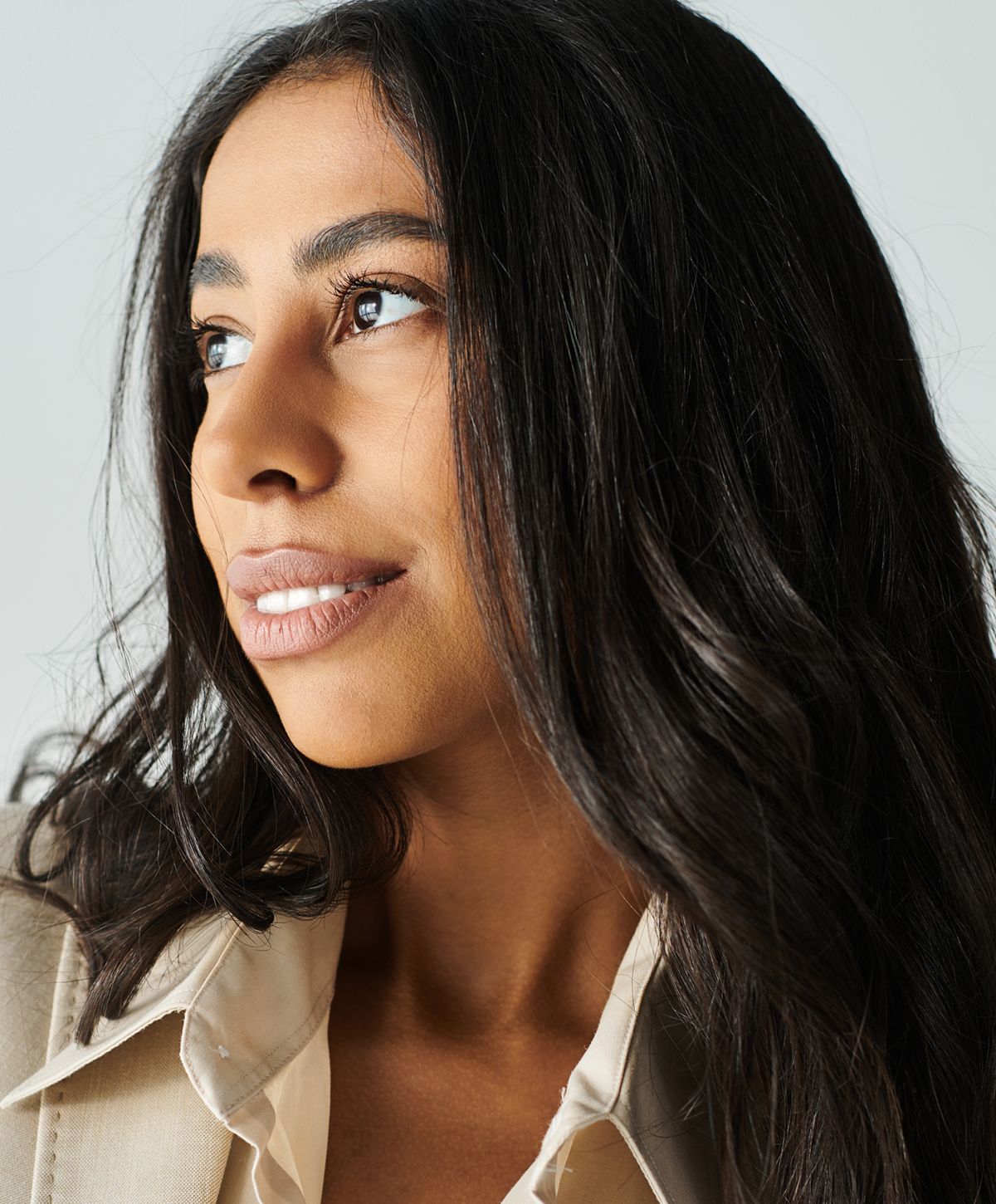 Woman with long, dark hair and soft smile.