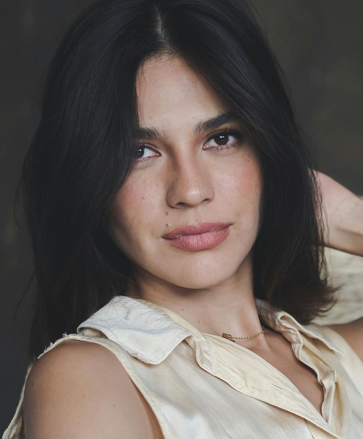 Portrait of a woman with long dark hair.