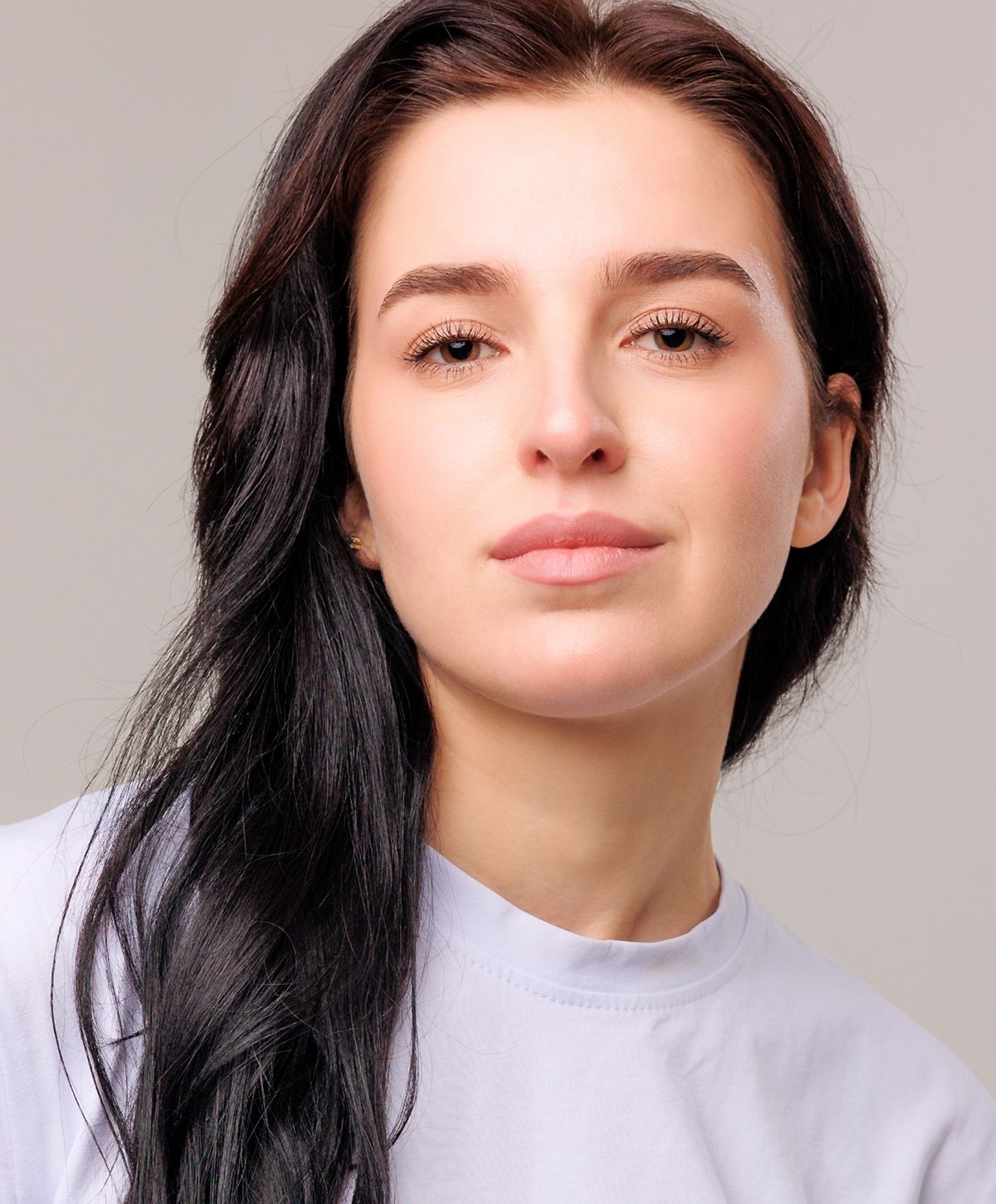 Woman with long black hair and natural makeup.