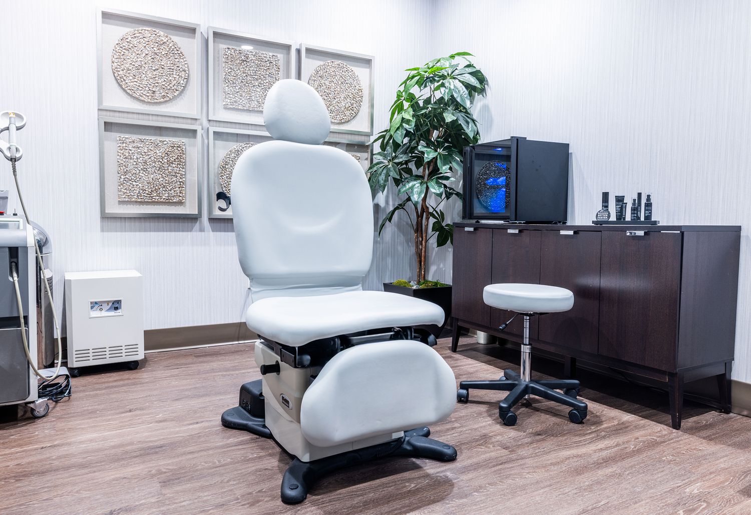 Modern treatment room with adjustable chairs and decor.