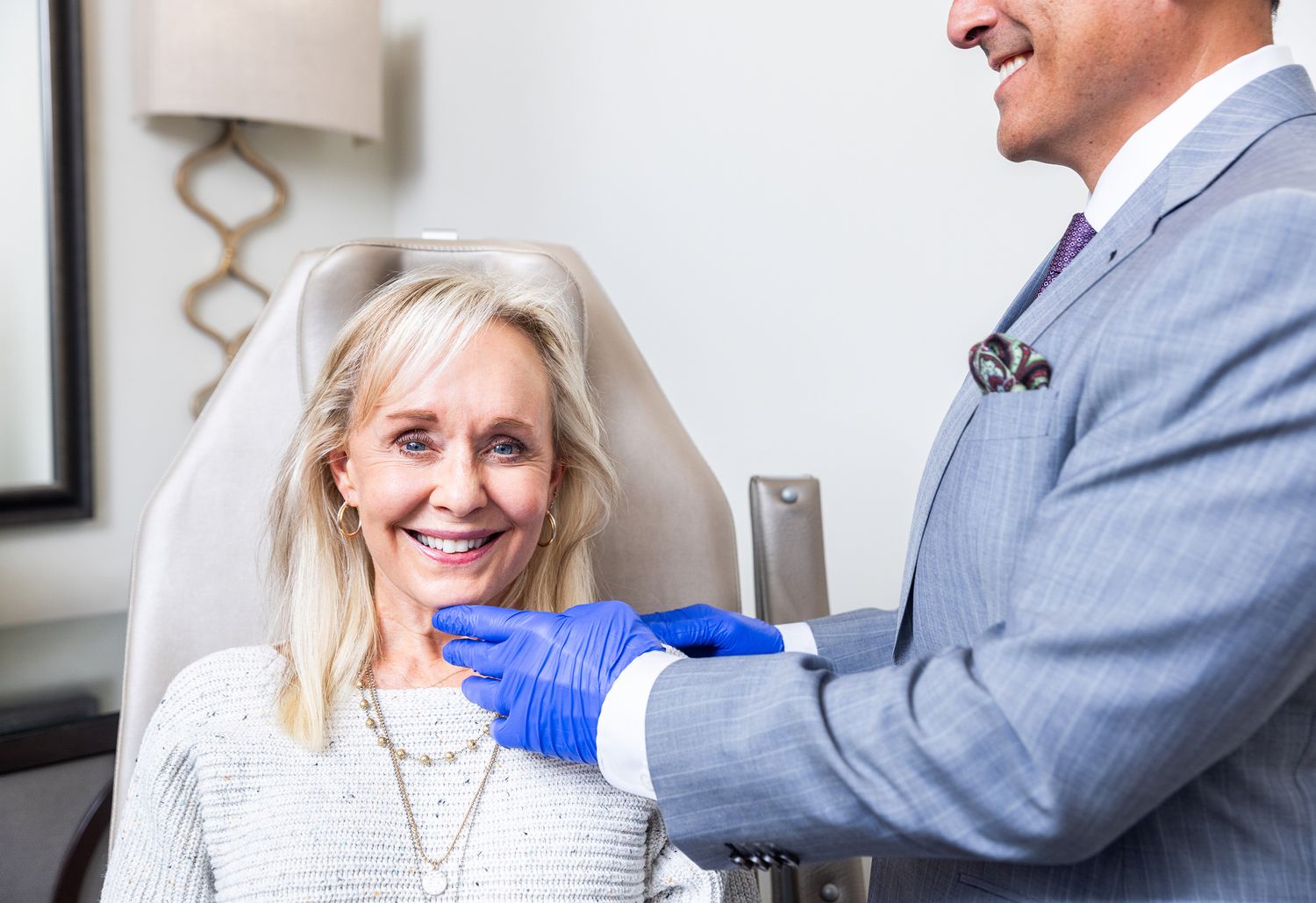 Smiling woman in a medical consultation setting.