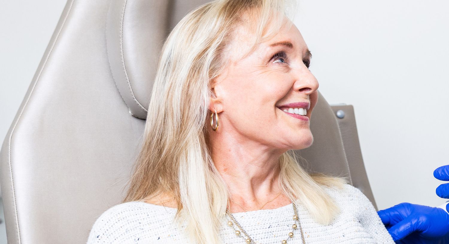 Woman smiling during a medical procedure.