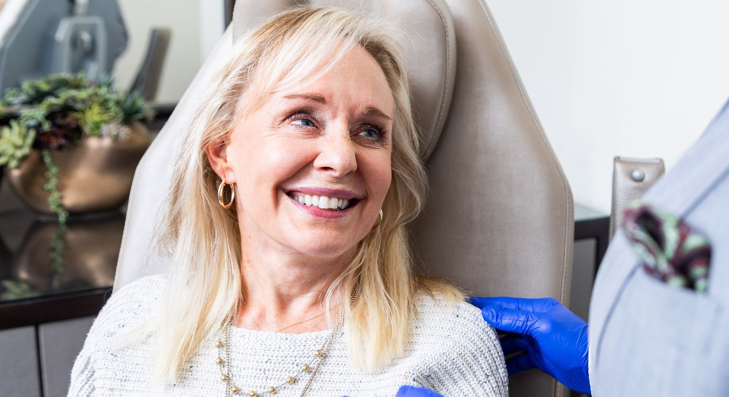 Smiling woman in medical office setting.